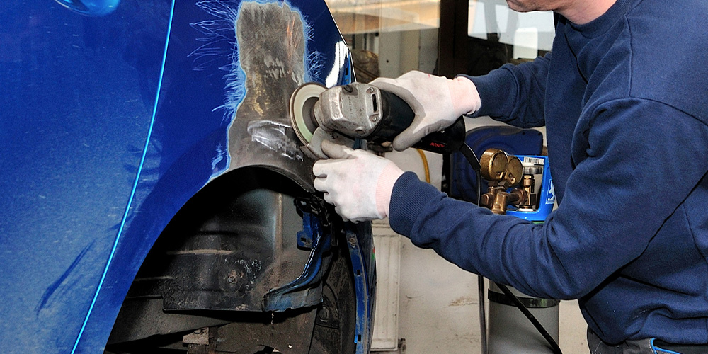 Image of Employee Working on A Car